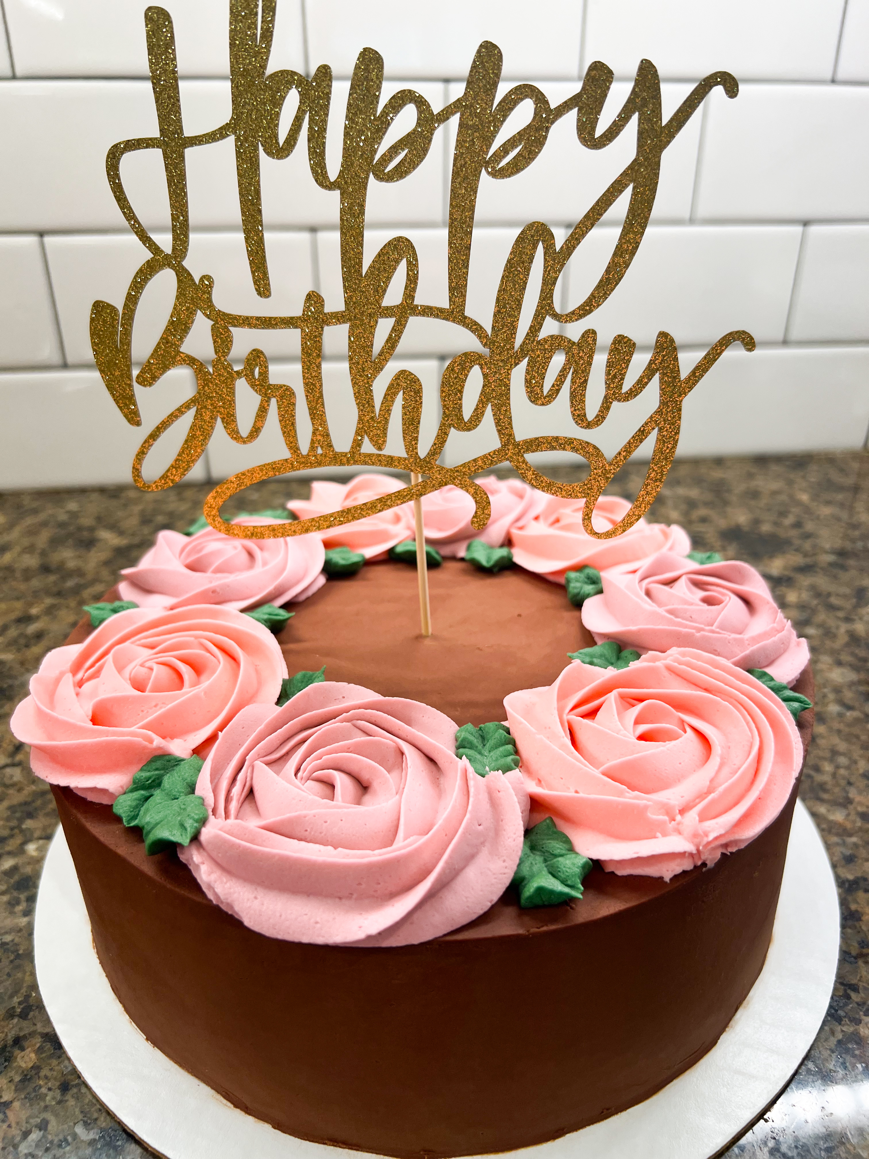 cake with roses and gold topper